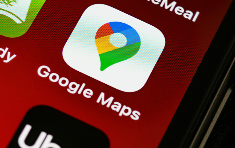 A close-up photograph of a smartphone screen displaying the Google Maps app icon, emphasizing the platform's role in local SEO and business discovery for small businesses.