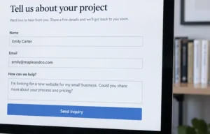 Person filling out a website contact form on a desktop computer in an office.